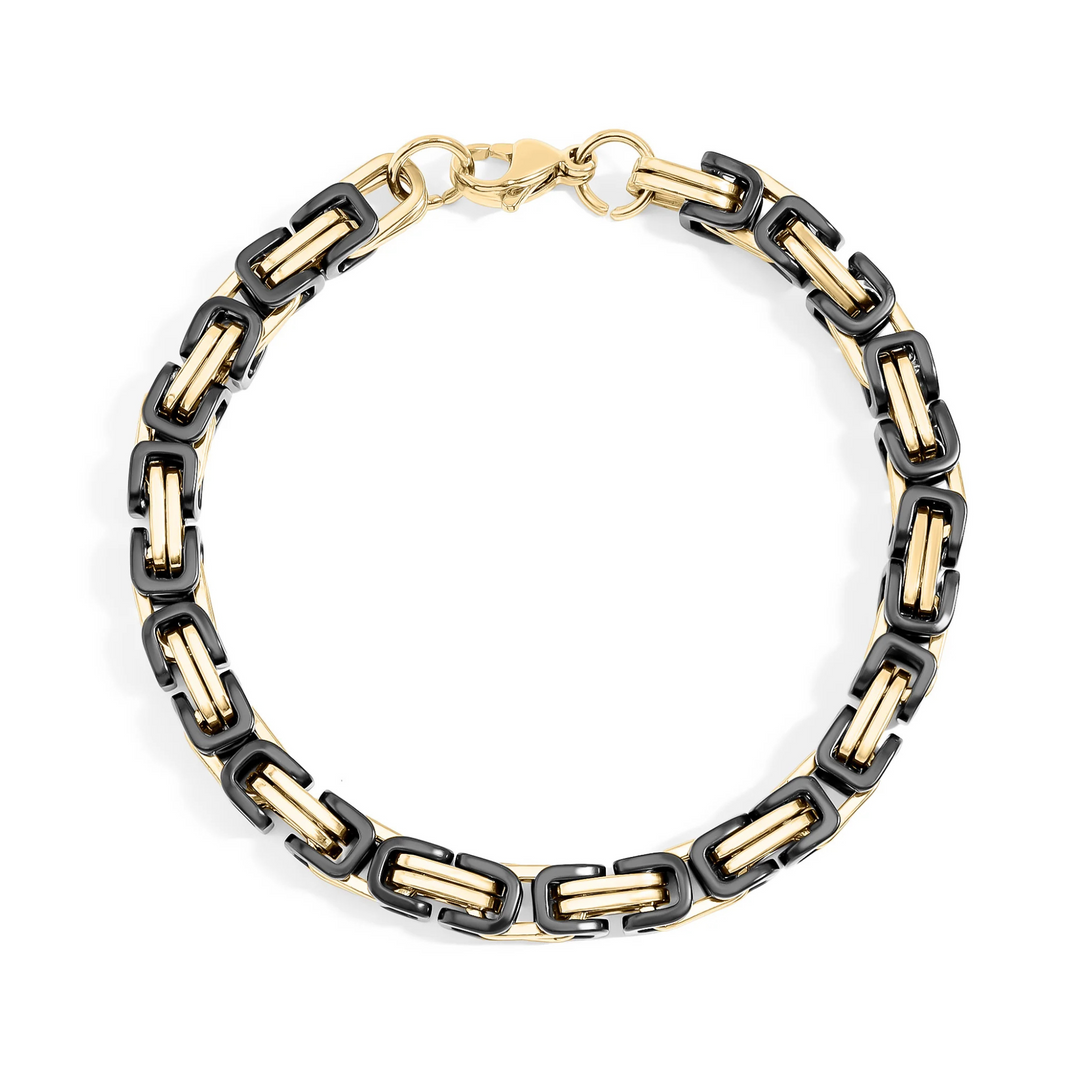 Bracelet with black and gold chain links on a white background