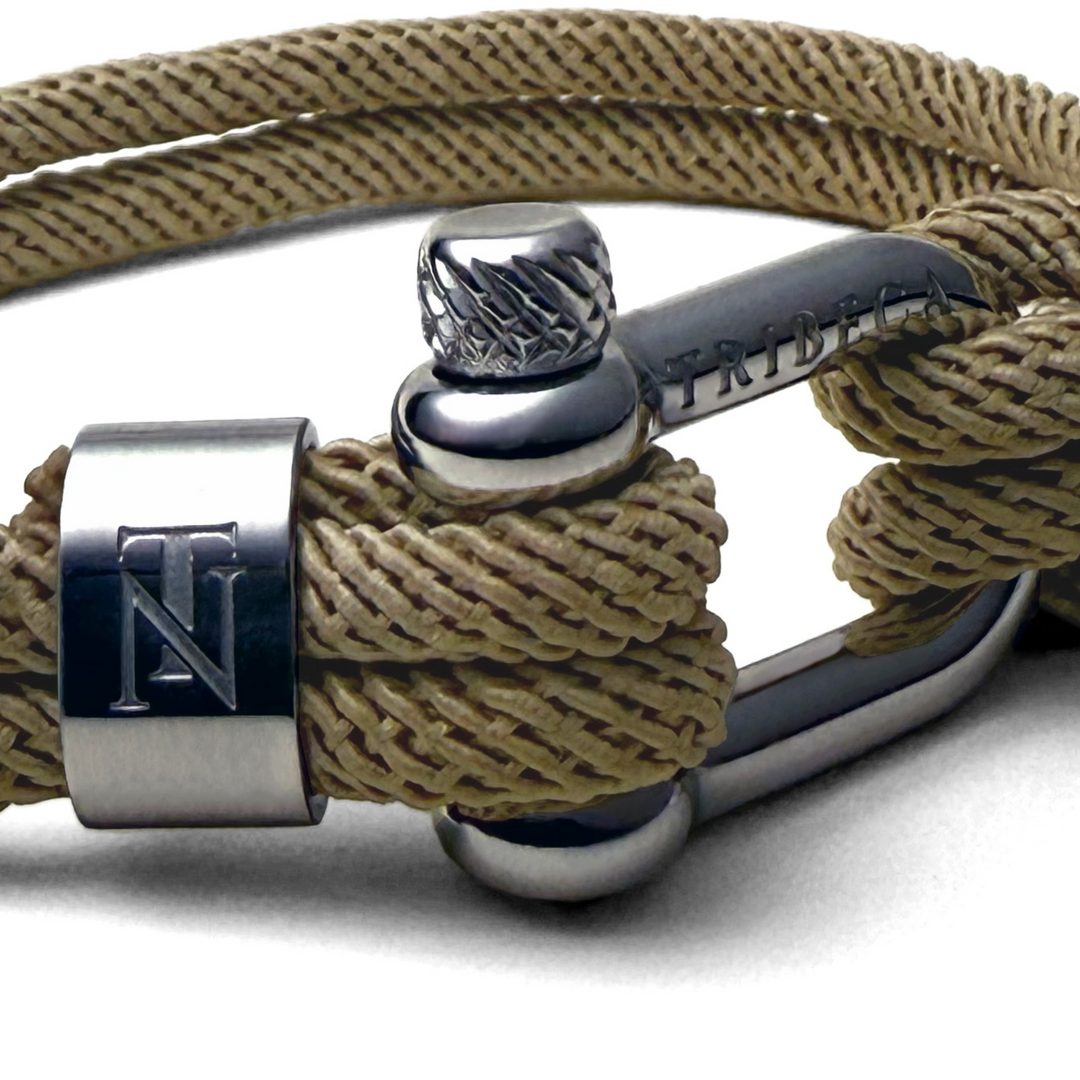 A close up image of a stainless steel clasp on a rope bracelet 