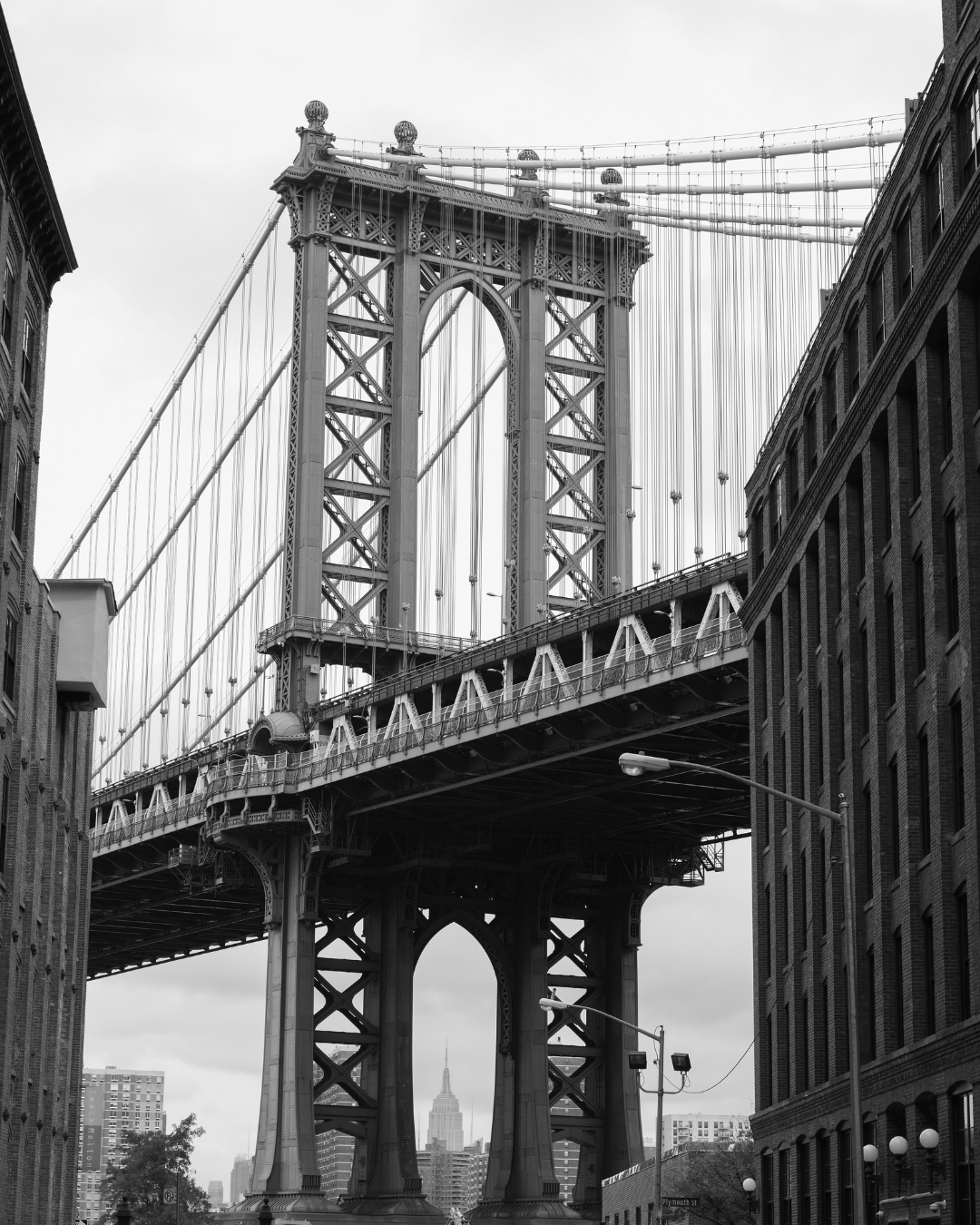 A black and white image of the Brooklyn Bridge taken from the Dumbo neighborhood in Brooklyn 
