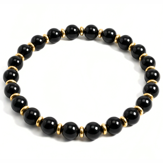 Black beaded bracelet with gold accents on a white background