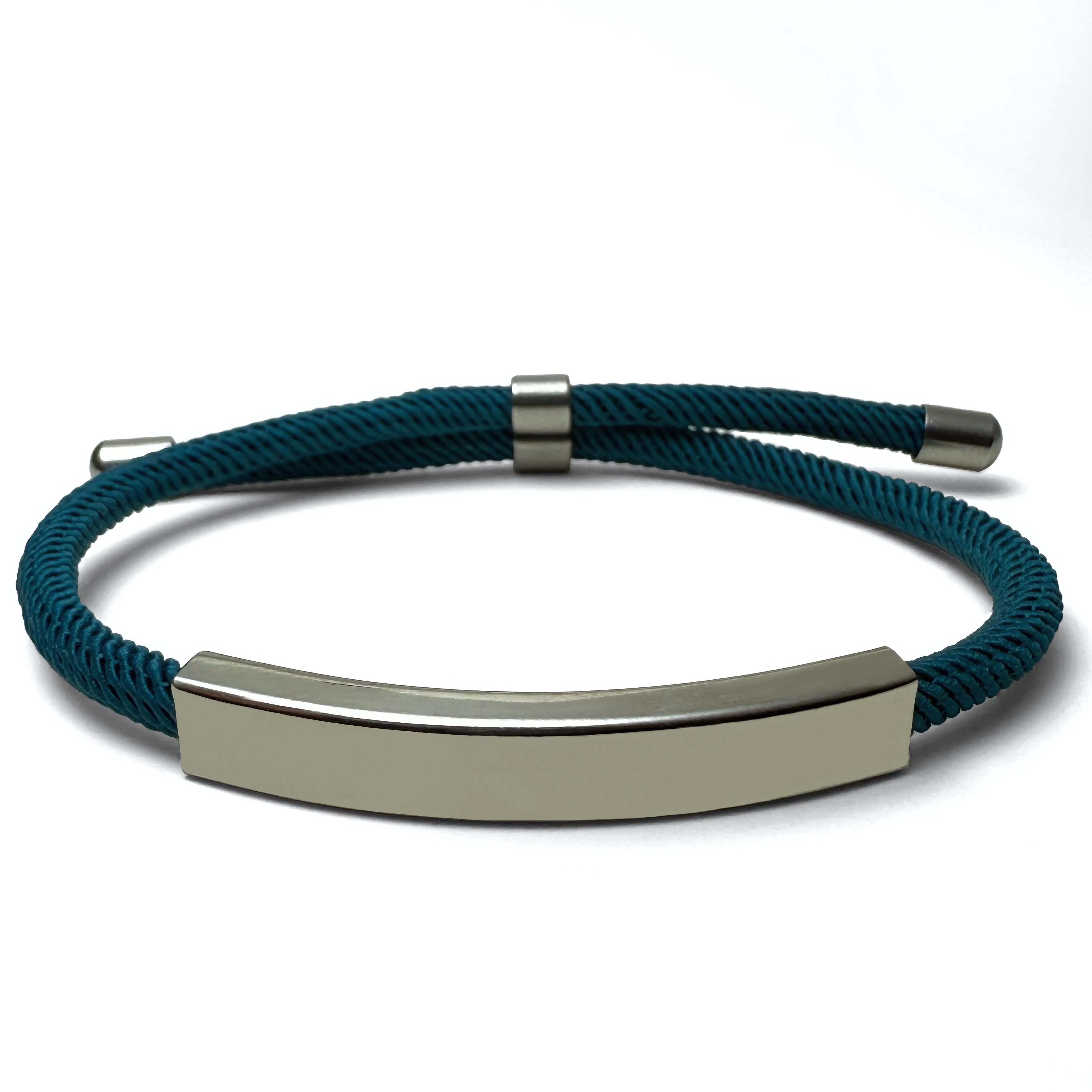 A teal-colored bracelet with a metallic bar centerpiece, displayed against a white background