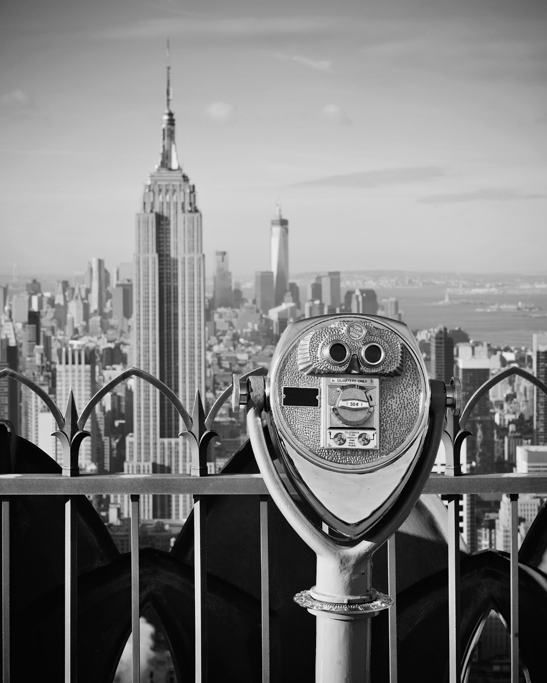 An image of New York City taken from atop a skyscraper with a viewfinder int he image 