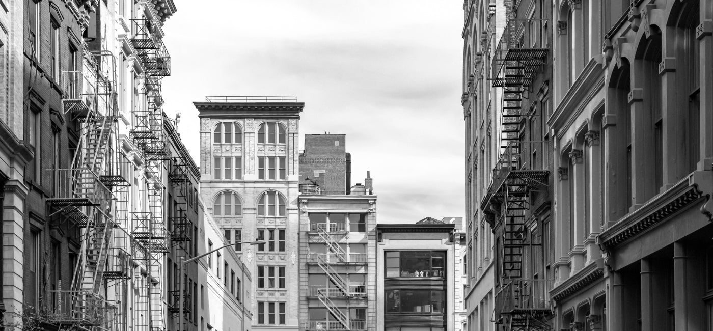 A black and white photo of buildings in New York City 
