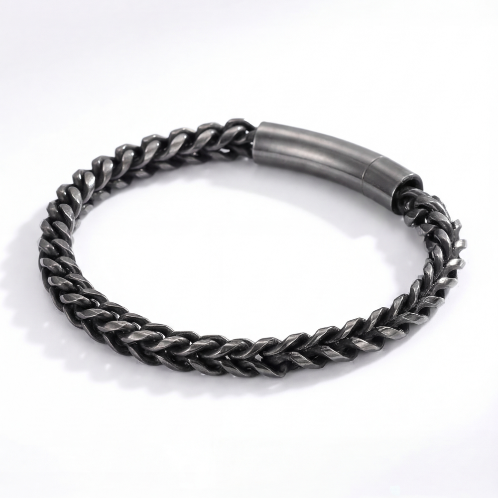 Black braided bracelet on a white background