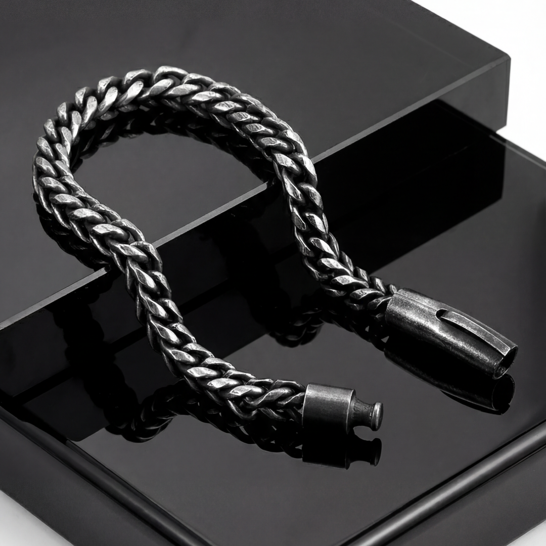 Black braided cable with metal connectors on a reflective black surface