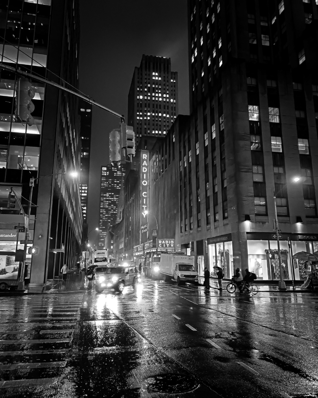 A black and white photo of the street outside of Radio City Music Hall in New York City 