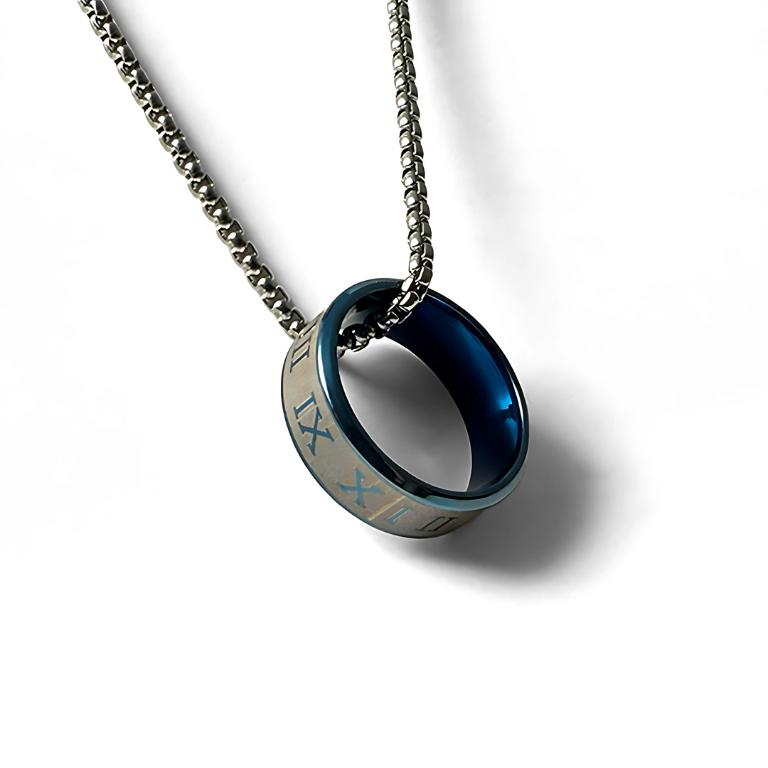 This image features a stylish necklace titled "Ring Necklace Midnight". The necklace presents a unique design with a circular pendant that resembles a ring, accentuated by a striking blue interior and intricate engravings along its exterior.