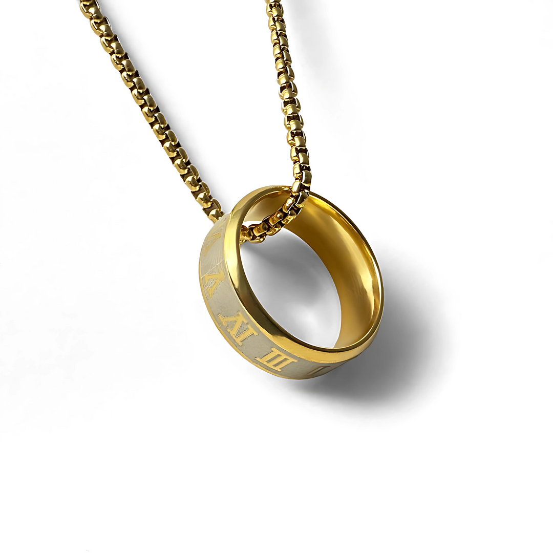 A gold-colored ring with chain link chain on a white background