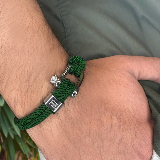 A green rope bracelet on a man's wrist