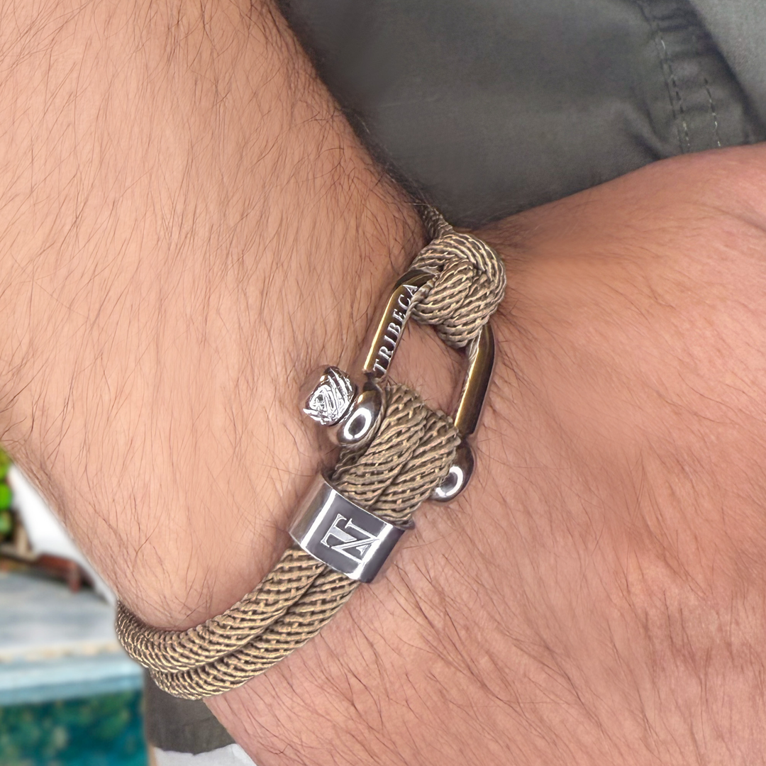 A man wearing a beige rope bracelet with a metal clasp